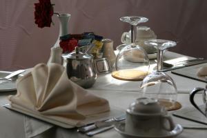 a table with plates and glasses and napkins on it at The Swiss Cottage, Shanklin in Shanklin