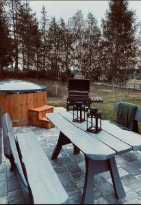 a picnic table with a piano on a patio at Dom z balią na Kaszubach-Widokova in Borucino