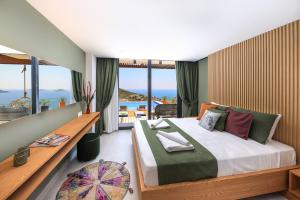 a bedroom with a bed with a view of the ocean at Villa Pax - Kalkan Villa in Kas