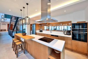 a kitchen with wooden cabinets and white counter tops at Villa Pax - Kalkan Villa in Kas