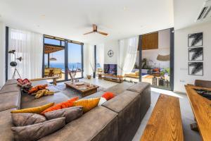 a living room with a large brown couch at Villa Pax - Kalkan Villa in Kas