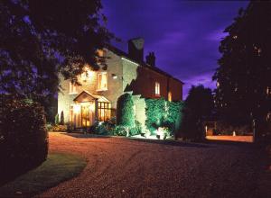 a large house at night with its lights on at Golborne Manor Bed and Breakfast in Chester