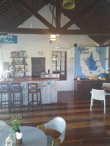 a restaurant with a bar and tables and chairs at DaRosa Del Mar in Santa Monica