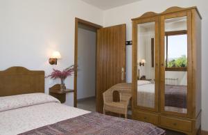 a hotel room with two beds and a mirror at Apartamentos La Cruz de Paderne in Navia