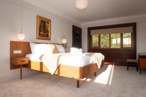 a bedroom with a large bed and a window at The Old Mount Manor - Causeway Coast in Coleraine