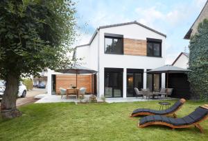 a house with a yard with chairs and tables at Chalet 48 in Mayen