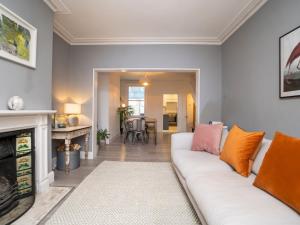 a living room with a white couch and a fireplace at Pass the Keys Lovely 2 bed home in Larkhall with street parking in Bath