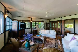 a living room with white couches and a table at Elysia Nongsa 70 Batam Luxury Villa in Nongsa