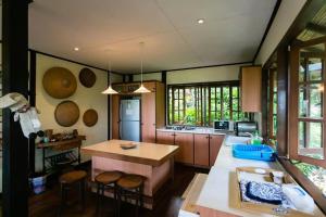 a kitchen with a table and some chairs in it at Elysia Nongsa 70 Batam Luxury Villa in Nongsa