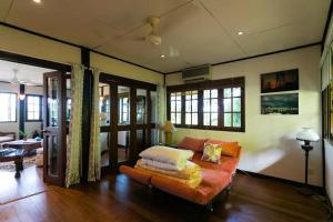 a living room with a couch and some windows at Elysia Nongsa 70 Batam Luxury Villa in Nongsa