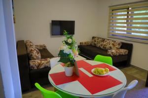 a living room with a table and a couch at Holiday Homes Pozitiva in Bihać