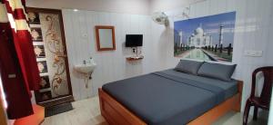 a bedroom with a bed and a picture of a mosque at S.S.K RESIDENCY in Chennai