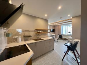 a kitchen with a sink and a counter top at Apartments in Dobele city center - Pilsētas Māja in Dobele