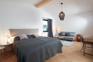 a bedroom with a bed and a living room at Chalet 48 in Mayen