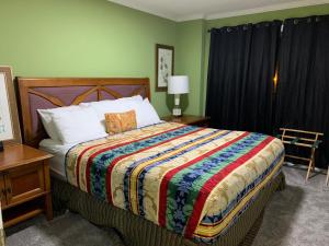 a bedroom with a large bed with a colorful blanket at 6 King beds and More, Chic Cordova Near Shopping in Memphis