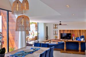 a living room with a blue couch and a table at Villa Lapis - Kalkan Villa in Kas