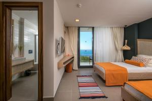 a bedroom with a bed and a view of the ocean at Villa Lapis - Kalkan Villa in Kas +63 photos
