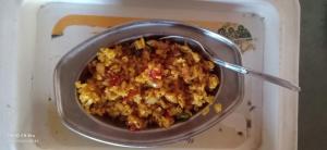 a bowl of food with a spoon in it at Hotel Raj Guest House in Jaipur