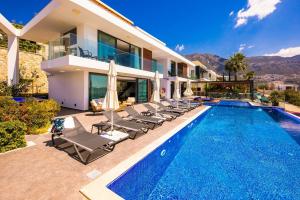 a villa with a swimming pool and a house at Villa Lapis - Kalkan Villa in Kas