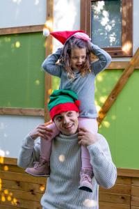 a young girl is sitting on top of a mans head at Magic Robin Hood in Albir