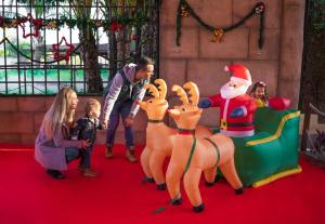 a family with a santa claus and reindeer on a roller coaster at Magic Robin Hood in Albir