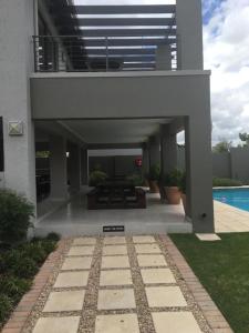 a patio with a picnic table and a pool at Lovely, Modern, Contemporary 1 Bedroom Apartment. in Sandton