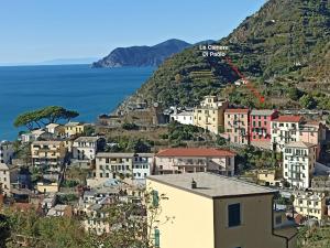 a town on a hill with a red arrow on it at Le Camere Di Paolo in Riomaggiore