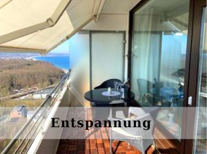 a balcony with a table and a view of the ocean at Top - Apartment mit Aussicht in Timmendorfer Strand