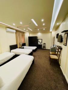 pokój hotelowy z 3 łóżkami i telewizorem w obiekcie Esperanza Petra w mieście Wadi Musa