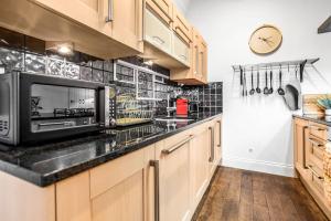 a kitchen with a counter top with a microwave at Beautiful 2 bed apartment in the heart of the city in Norwich
