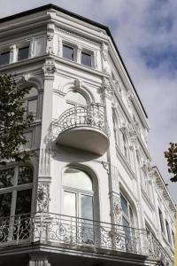 a white building with a balcony on the side of it at Sleephotels Casino in Hamburg