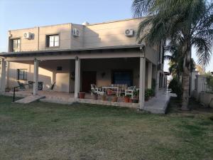 una casa con una palmera delante de ella en Las Tres Marías en Salta