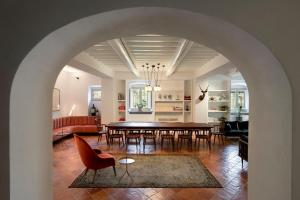 a dining room and living room with a table and chairs at Casolese di Vignamaggio in Greve in Chianti