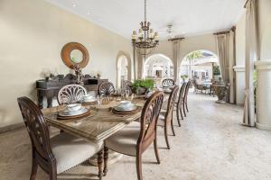 a dining room with a wooden table and chairs at Royal Westmoreland- Wild Cane Ridge 2 by Island Villas in Saint James