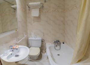 a bathroom with a white toilet and a sink at Hostal Santo Domingo de Silos in Santo Domingo de Silos