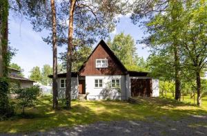 a home with a barn with trees in the foreground at Türi Puhkemaja - Murunella in Türi