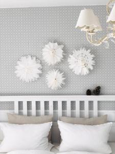 a bedroom with white flowers on the wall at Das Ruebezahl in Reit im Winkl