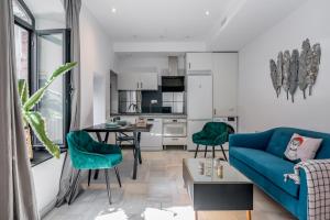 a living room with a blue couch and a table at Dreams of Marbella in Marbella