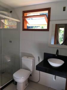 łazienka z toaletą, umywalką i oknem w obiekcie Brandt Huss w mieście Santa Teresa