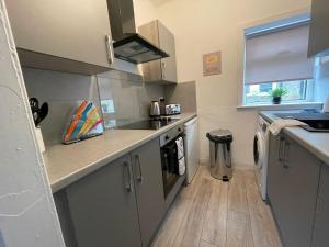 a kitchen with a sink and a counter top at Cardonald House in Glasgow