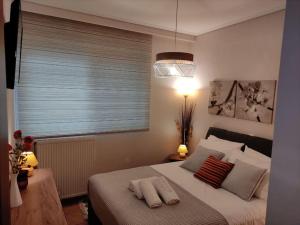 a bedroom with a bed with two pillows on it at Little heaven in Alimos/Athens! in Athens