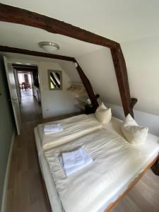 a bed with two towels on it in a room at Apartment Klara in Lübeck