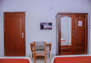 una stanza con tavolo, sedia e specchio di Room in BB - Martin Aviator Hotel a Kigali
