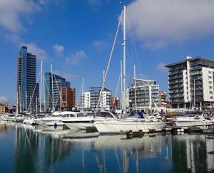 a group of boats docked in a harbor with buildings at Wilton Retreat in Southampton