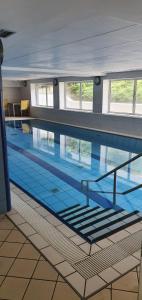 a large swimming pool in a building at Ferienwohnung mit Seeblick und Schwimmbadnutzung in Cuxhaven in Cuxhaven