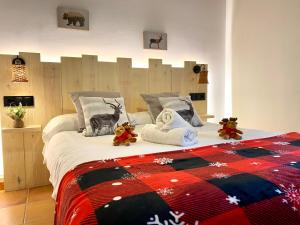 una camera da letto con un grande letto con sopra degli animali di peluche di Apartaments Alta Muntanya a Barruera