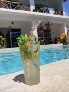 a drink sitting on a table next to a pool at Hakuna Matata Boutique in Paje