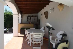 comedor con mesa y sillas en el patio en Les chambres d'hôtes d'Eloïse, piscine privée, en Aramon