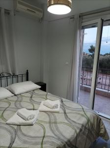 A bed or beds in a room at Eirini's Apartment