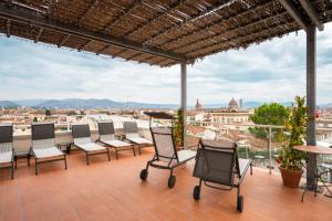 a group of chairs on a patio with a view at Hotel Kraft in Florence